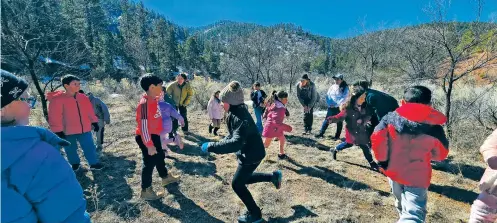  ?? COURTESY PHOTO ?? Second graders from El Camino Real Academy play Space Invaders on the Chamisa Trail as part of a Mountain Kids! outdoors program