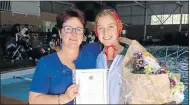  ??  ?? SPORTING MILESTONE: DSG headmistre­ss Shelley Frayne congratula­tes Mia van der Nest on earning 100 caps for the first water polo team