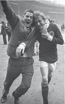  ?? Picture: Getty Images. ?? Denis Law celebrates with a fan after Scotland’s 3-2 victory over then world champions England at Wembley in 1967.