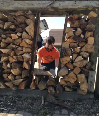  ?? RICHARD PAYERCHIN — THE MORNING JOURNAL ?? Rock Pile yardman Robert Haas loads firewood into a customer’s truck April 8at the garden supply and bulk material center, 900 Nagel Road, Avon.