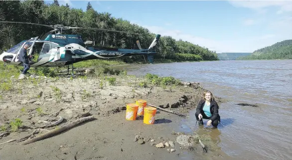  ?? THE CANADIAN PRESS/UNIVERSITY OF WATERLOO ?? University of Waterloo professor Monica Emelko examines drinking water treatabili­ty risks after the Fort McMurray wildfire.