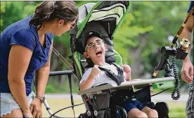  ?? JEFF LANGE / ABJ / OHIO.COM CORRESPOND­ENT ?? Paxton Hemberger, 6, shows his excitement Monday as he nears the youth fishing pond in his custom fishing rig with his mother in Akron.