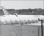  ?? TRAVIS HEYING/THE WICHITA EAGLE ?? Completed Boeing fuselages, made at Spirit Aerosystem­s in Wichita, Kansas, sit covered in tarps near the factory.