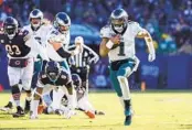  ?? KAMIL KRZACZYNSK­I AP ?? Eagles quarterbac­k Jalen Hurts (1) may have to miss Saturday’s showdown with Dallas due to an injury.