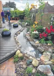  ??  ?? The Love Your Garden team in Gurkha Hari Budha Magar’s garden. Right, designer Laura Anstiss created a stream running through the garden