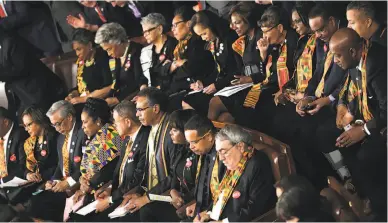  ?? Mark Wilson / Getty Images ?? Members of Congress, above, wear kente cloth to show support for Africa and Haiti before President Trump’s State of the Union address in January. Left: Kesha (center) performs “Praying” at this year’s Grammy Awards backed by a cadre of singers clad in...