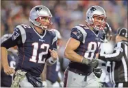  ?? AP-Charles Krupa, File ?? In this 2016 file photo, New England Patriots quarterbac­k Tom Brady (12) and tight end Rob Gronkowski head to the sideline in Foxborough, Mass. Gronkowski has agreed to a reunion with Brady. The agent for the retired New England star confirmed Tuesday that pending completion of a physical, Gronkowski has agreed to play for the Tampa Bay Buccaneers, who are acquiring his rights from the Patriots.