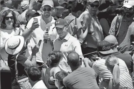  ?? JOHN WOIKE/HARTFORD COURANT VIA AP ?? Jordan Spieth, center, is welcomed by a large gallery while walking onto the first tee prior to the start of the third round of the Travelers Championsh­ip on Saturday at TPC River Highlands in Cromwell. Spieth maintained his one-shot lead heading into...