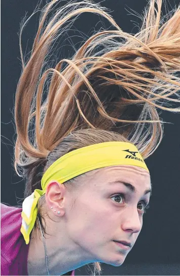  ?? Main Picture: SAEED KHAN/AFP ?? TOP SHOT: Aleksandra Krunic serves to Garbine Muguruza in Brisbane yesterday before Muguruza had to withdraw after suffering severe leg cramps.