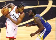  ?? VAUGHN RIDLEY/GETTY IMAGES/TNS ?? Kawhi Leonard, left, of the Raptors is defended by Draymond Green of the Warriors in the second half during Game Five of the NBA Finals on Monday in Toronto.