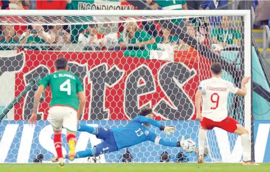  ?? — AFP ?? Mexico’s goalkeeper Guillermo Ochoa saves a penalty shot by Poland’s forward Robert Lewandowsk­i during the Qatar 2022 World Cup Group C match at Stadium 974 in Doha.