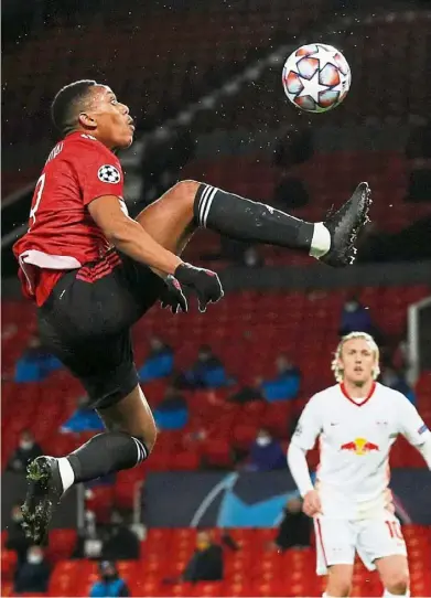  ?? — Reuters ?? Leap of faith: Manchester United’s Anthony Martial shoots at goal during their Champions League group match against Leipzig.