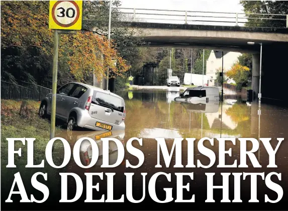  ?? GAYLE MARSH ?? Vehicles abandoned in floodwater on Heol Las, Birchgrove