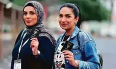  ?? AFP ?? Women display their passports as they arrive to cast their votes at a polling station in Kuwait City yesterday.