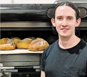  ?? ALEX BIELAK PHOTO ?? Chef Daniel Angus, owner of Terroir Artisan Bakery, with sourdough loaves about to come out of the oven.