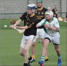  ??  ?? Adamstown’s Liam Stafford tries to get his shot away as Crossabeg-Ballymurn’s Shane O’Rourke attempts a hook.