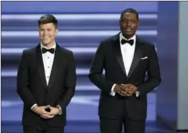  ?? PHOTO BY CHRIS PIZZELLO — INVISION — AP ?? Hosts Colin Jost, left, and Michael Che speak at the 70th Primetime Emmy Awards on Monday at the Microsoft Theater in Los Angeles.