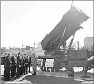  ?? AP/SHIZUO KAMBAYASHI ?? Vice President Mike Pence (fourth from left), inspects a PAC-3 intercepto­r missile system Wednesday in Tokyo with Japanese Defense Minister Itsunori Onodera (third from left).