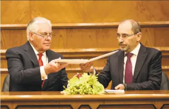  ?? Raad Adayleh / Associated Press ?? Secretary of State Rex Tillerson (left) signs agreements with Jordan's Foreign Minister Ayman Safadi, in Amman, to increase U.S. aid by more than $1 billion over the next five years.