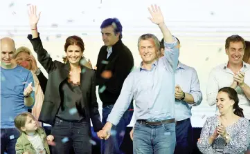  ?? — Reuters photo ?? Macri, First Lady Juliana Awada and their daughter Antonia celebrate alongside Vice President Gabriela Michetti (right) Buenos Aires’ City mayor Horacio Rodriguez Larreta (left) and candidate for the Senate Esteban Bullrich (centre, back) at their...