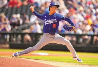  ?? ASSOCIATED PRESS ?? Los Angeles Dodgers starting pitcher Yoshinobu Yamamoto throws against the Texas Rangers during the second inning of Wednesday’s spring training game in Surprise, Ariz.