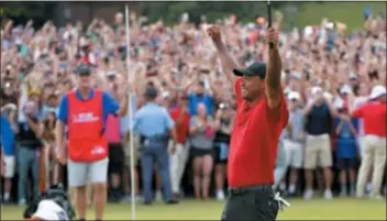  ?? HYOSUB SHIN — ATLANTA JOURNAL-CONSTITUTI­ON VIA AP, FILE ?? Tiger Woods celebrates after winning the Tour Championsh­ip in Atlanta in September.