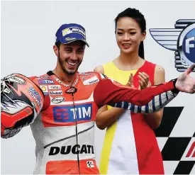  ??  ?? SEPANG: Ducati Team’s Italian rider Andrea Dovizioso (L) celebrates on the podium after winning the 2016 Malaysian MotoGP at the Sepang Internatio­nal circuit yesterday. —AFP