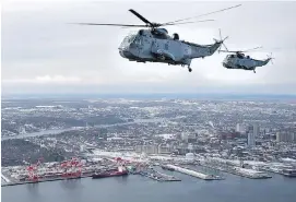  ?? ANDREW VAUGHN, THE CANADIAN PRESS ?? CH-124 Sea King helicopter­s fly over Halifax on Friday. The half-century-old helicopter­s will be replaced with the CH-148 Cyclone.