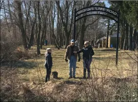  ?? RICHARD PAYERCHIN — THE MORNING JOURNAL ?? Marcia DePalma, president of the Brownhelm Historical Associatio­n, at right, discusses Brown’s Lake Road Cemetery in Vermilion with volunteers March 20during the cleanup day.