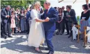  ??  ?? Karin Kneissl and Vladimir Putin dance during her wedding in Gamlitz, Styria, Austria.