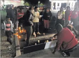  ?? Katelyn Newberg ?? Las Vegas Review-journal Sydney Harris, 33, stands closest to the front of posters rememberin­g her son, Lamadre Harris, after a vigil Wednesday. The teen died after a shooting Tuesday.