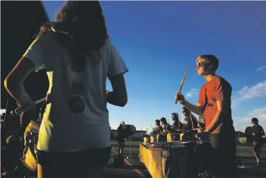  ?? Leah Millis / The Chronicle ?? Will Belford drums during a 12-hour marching band rehearsal at Homestead High School in Cupertino.