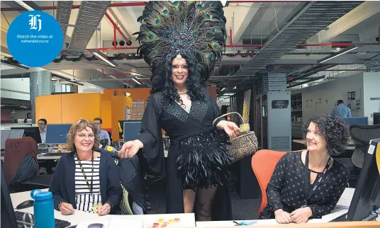  ?? Picture / Nick Reed ?? Marcel Goulding’s flamboyant alter ego Marcella hands out lollipops to co- workers at ASB Bank to promote Pride Week. Tamsyn Parker