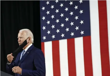  ?? Ap FIle pHoToS ?? OUT OF THE BASEMENT: Presumptiv­e Democratic presidenti­al candidate Joe Biden takes off his mask before a campaign event in Wilmington, Delaware, on Tuesday. Below. reporters social distance during the event.