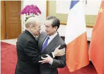  ?? Agence France-presse ?? Wang Yi (right) meets French Foreign Minister Jean-yves Le Drian at Diaoyutai State Guesthouse in Beijing on Friday.