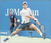  ?? CAROLYN KASTER — THE ASSOCIATED PRESS ?? No. 6-seeded Novak Djokovic returns a shot to Joao Sousa during his fourth-round win at the U.S. Open on Monday