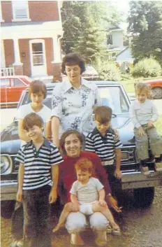  ?? SUPPLIED PHOTO ?? Happier times for William O’Sullivan, bottom left winking at the camera, at about nine years of age. His mother, Madonna Joan, is standing surrounded by her other sons and relatives in this undated family photo.