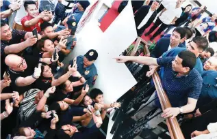  ??  ?? TAKING A STAND – President Duterte greets his supporters on the sidelines of the annual convention of the Prosecutor­s’ League of the Philippine in Puerto Princesa City, Palawan, Thursday. Addressing the convention, the President declared he will not allow China to occupy Pag-asa island, saying it belongs to the Filipinos. (Malacañang photo)