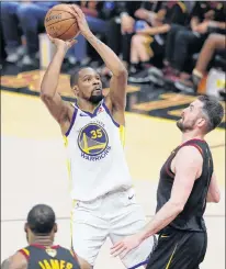  ?? AP PHOTO ?? Golden State Warriors’ Kevin Durant shoots over Cleveland Cavaliers’ Kevin Love during the second half of Game 3 of the NBA Finals Wednesday in Cleveland.