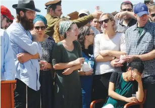  ?? (Avshalom Sassoni/Maariv) ?? SGT. SHLOMO Rindenow’s family members mourn at his funeral yesterday at Netzer Hazani.