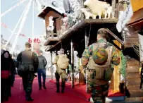  ?? Reuters ?? Belgian soldiers patrol along a Christmas market ahead of New Year’s celebratio­ns in central Brussels on Friday. —