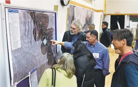  ?? CLYDE MUELLER/NEW MEXICAN FILE PHOTO ?? Art Valverde with the U.S. Bureau of Reclamatio­n points out details to attendees at a Feb. 16 hearing in Tesuque on the proposed regional water system in Pojoaque Valley. Santa Fe County officials are concerned about the state’s commitment to the...