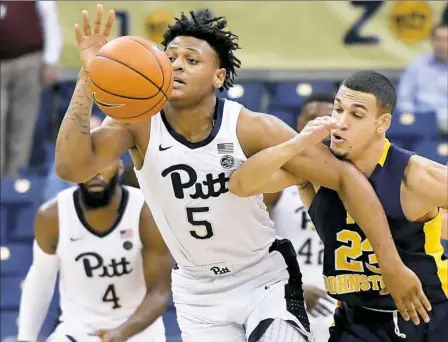  ?? Matt Freed/Post-Gazette ?? Pitt’s Au’Diese Toney, left, steals the ball from Pitt-Johnstown’s Josh Wise in an exhibition game Thursday night at Petersen Events Center. PItt defeated Pitt-Johnstown, 78-59.