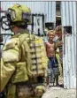  ?? CPL. BRANDON GREY / DEPARTMENT OF DEFENCE ?? Boys watch the Australian army during a community engagement patrol through Honiara, Solomon Islands, on Saturday.