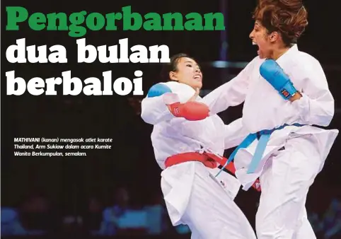  ??  ?? MATHIVANI (kanan) mengasak atlet karate Thailand, Arm Sukiaw dalam acara Kumite Wanita Berkumpula­n, semalam.