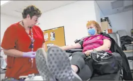  ?? Michael Quine Las Vegas Review-journal @Vegas88s ?? Eva Clappa takes a donation from Susan Edwards during a blood drive on March 24. Southern Nevada has had 205 blood drives canceled during the statewide shutdown.