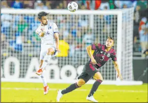  ?? Brandon Wade The Associated Press ?? El Salvador’s Joaquin Rivas, left, a former standout with Las Vegas High and UNLV, heads a ball away from Osvaldo Rodriguez in a 1-0 CONCACAF group victory for Mexico on July 18 in Dallas.