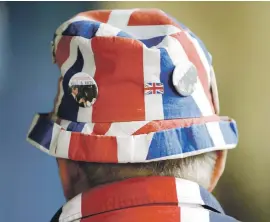  ?? Picture: Reuters ?? CONUNDRUM. A fan of the royal family wears union flag-themed attire yesterday. More Scots who support the UK are backing the Scottish National Party as they are disillusio­ned with Labour.