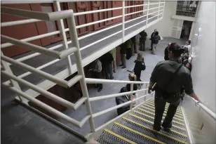  ?? RICH PEDRONCELL­I — THE ASSOCIATED PRESS ?? Reporters inspect one of the two-tiered cell pods in the Secure Housing Unit at the Pelican Bay State Prison near Crescent City, Calif., in August 2011.