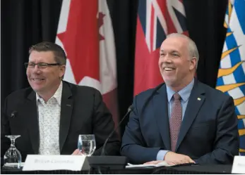  ?? CP PHOTO ?? British Columbia Premier John Horgan, right, and Saskatchew­an Premier Scott Moe share a laugh at the Western Premiers’ Conference in Yellowknif­e, N.T., on Wednesday.